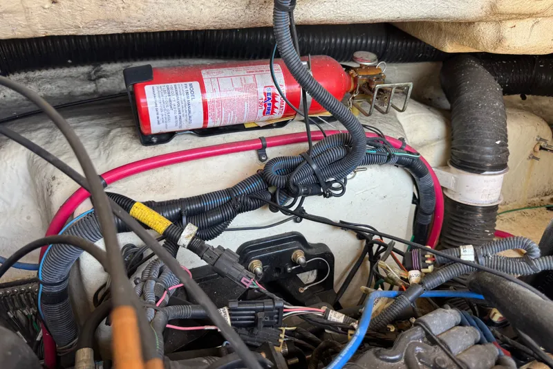 Slide: The Image of Engine compartment of a 2003 Searay 270 Sundeck with fire extinguisher and wiring. - 31
