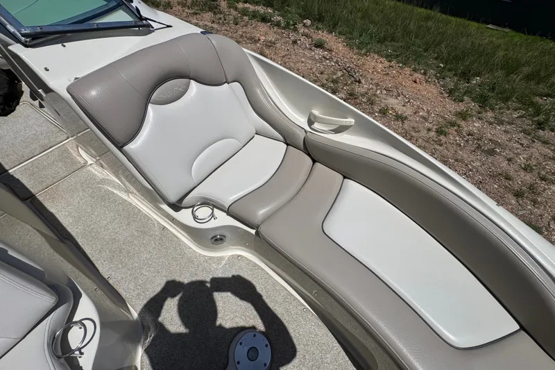 Slide: The Image of 2003 Searay 270 Sundeck boat interior with cushioned seating and cup holders. - 24