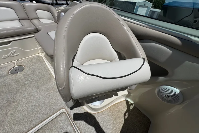 Slide: The Image of 2003 Searay 270 Sundeck interior with beige seating and speaker detail. - 25