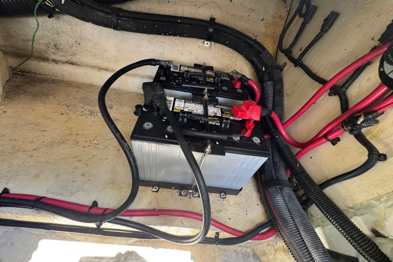 Slide: The Image of Battery compartment of a 2003 Searay 270 Sundeck with wiring and connections. - 30