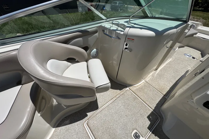 Slide: The Image of Interior of a 2003 Searay 270 Sundeck boat, featuring seating and helm area. - 13
