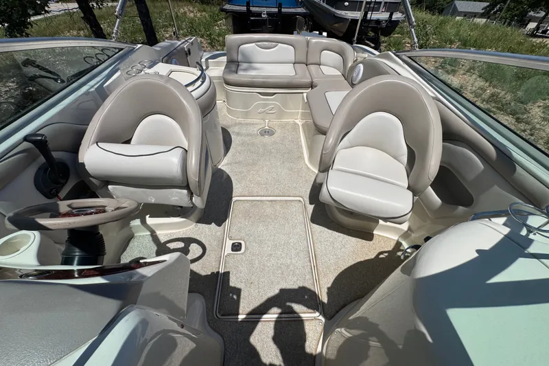 Slide: The Image of 2003 Searay 270 Sundeck interior with plush seating and steering wheel, showcasing spacious design. - 9