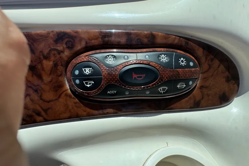 Slide: The Image of Control panel of a 2003 Searay 270 Sundeck boat with various function buttons. - 27