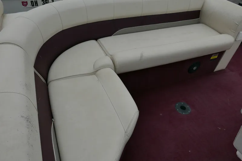 Slide: The Image of 2002 Avalon Tahoe Vista boat interior with cream seating and maroon carpet. - 11
