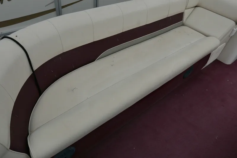 Slide: The Image of 2002 Avalon Tahoe Vista boat interior with white and maroon seating on red carpet. - 6