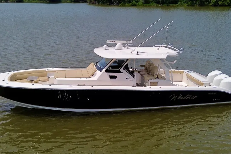 Slide: The Image of 2017 Pursuit S 408 Sport boat on calm water, featuring sleek design and spacious seating. - 10