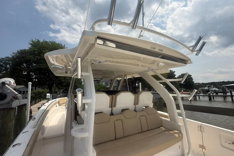 Slide: The Image of 2017 Pursuit S 408 Sport boat docked, featuring spacious seating and sleek design. - 55