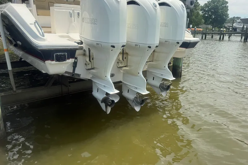 Slide: The Image of 2017 Pursuit S 408 Sport boat with triple Yamaha outboard engines on a dock. - 63