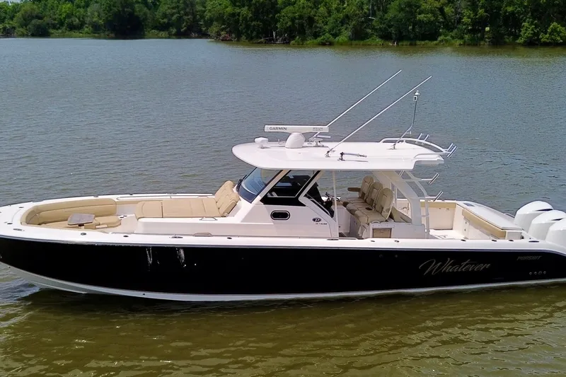 Slide: The Image of 2017 Pursuit S 408 Sport boat on calm water, featuring sleek design and spacious seating. - 2