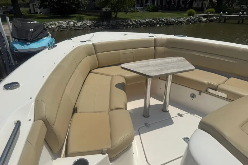 Slide: The Image of Luxurious seating area on a 2017 Pursuit S 408 Sport boat with a central table. - 35