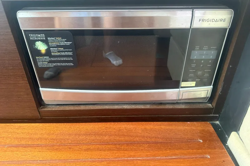 Slide: The Image of Frigidaire microwave installed in a 2017 Pursuit S 408 Sport boat kitchen. - 54