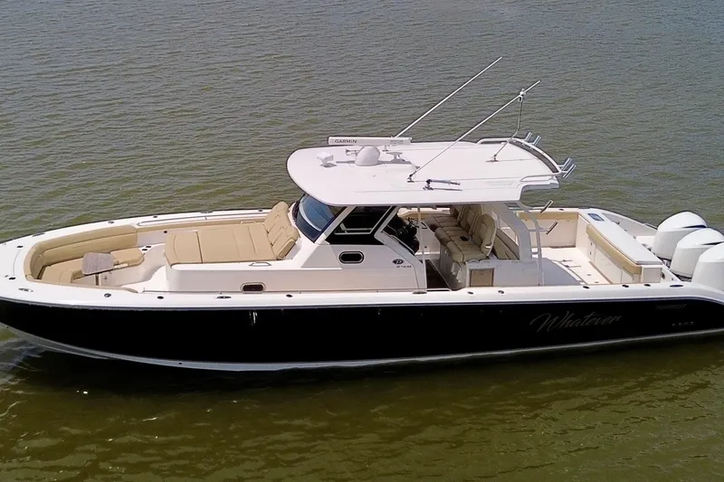 Slide: The Image of 2017 Pursuit S 408 Sport boat on water, featuring sleek design and spacious seating. - 1