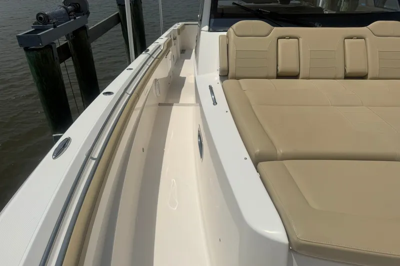 Slide: The Image of 2017 Pursuit S 408 Sport boat with beige seating and sleek white deck. - 41
