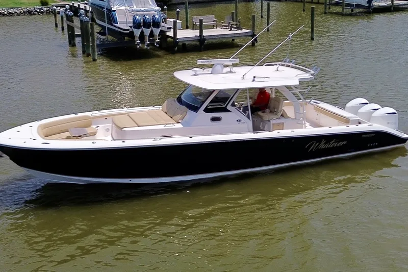 Slide: The Image of 2017 Pursuit S 408 Sport boat on water, featuring sleek design and powerful engines. - 15