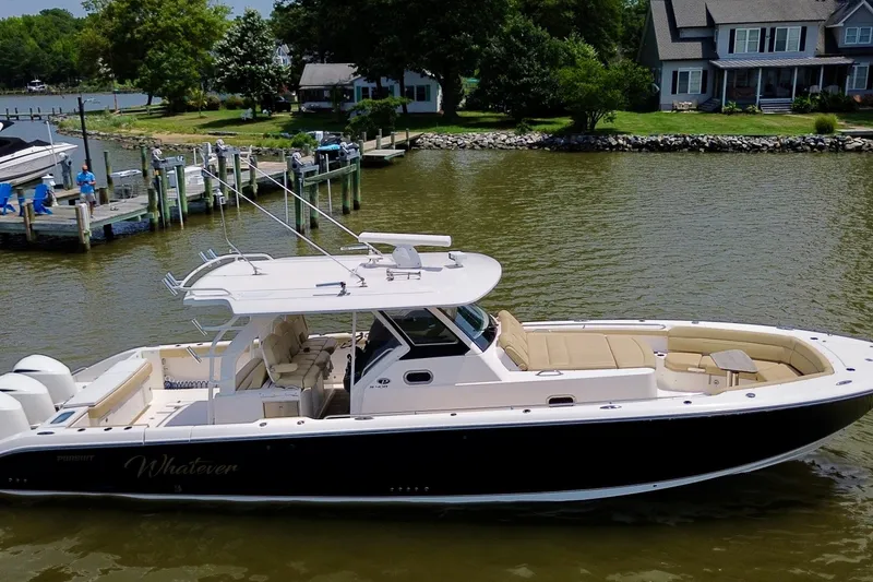 Slide: The Image of 2017 Pursuit S 408 Sport boat docked on a serene waterfront. - 11