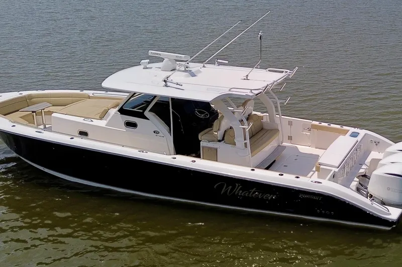 Slide: The Image of 2017 Pursuit S 408 Sport boat on water, featuring sleek design and spacious seating. - 3