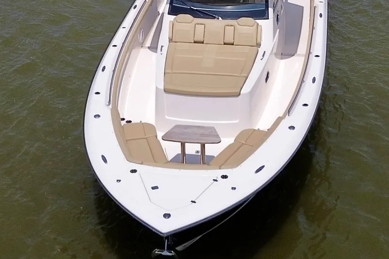 Slide: The Image of 2017 Pursuit S 408 Sport boat with spacious deck and seating on water. - 9