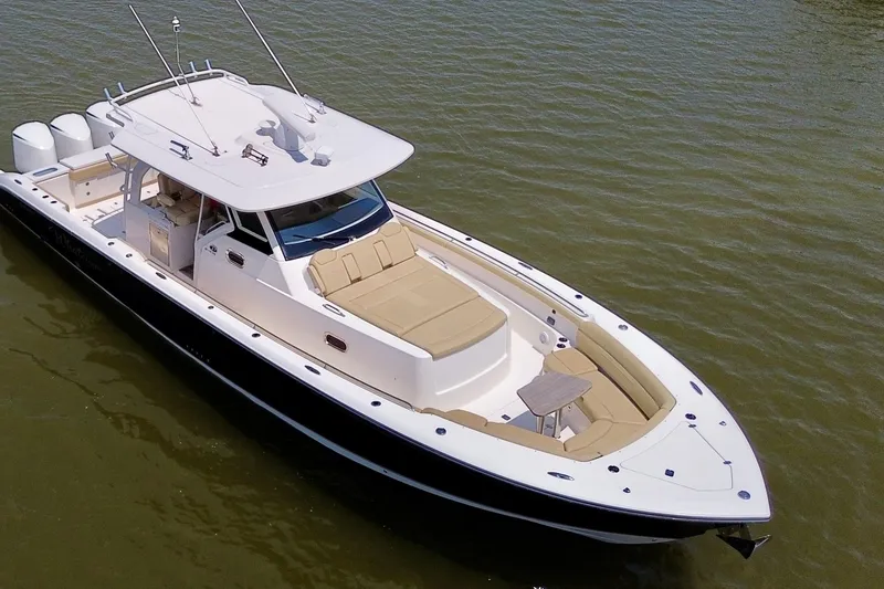 Slide: The Image of 2017 Pursuit S 408 Sport boat on calm water, featuring sleek design and spacious deck. - 8