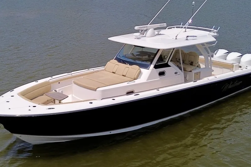 The Image of 2017 Pursuit S 408 Sport boat on calm water, featuring sleek design and spacious seating. - 0