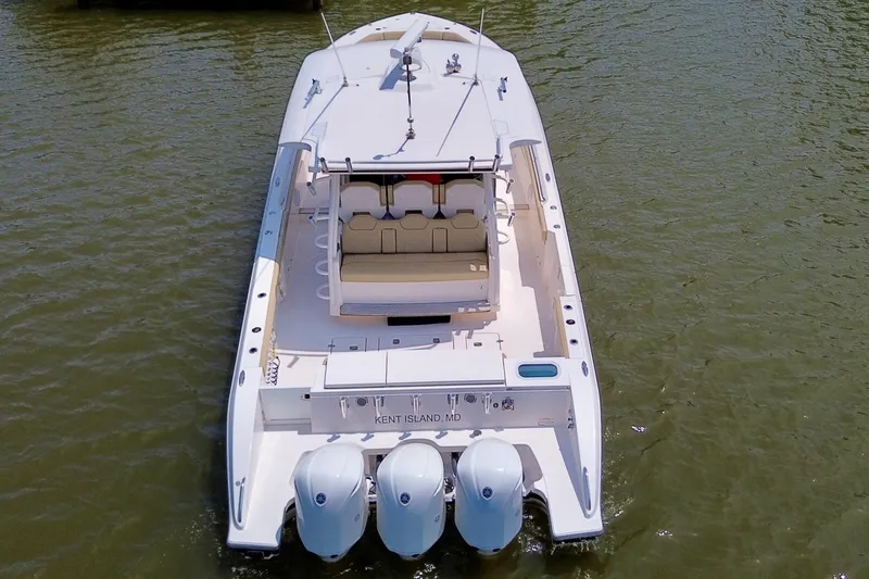 Slide: The Image of 2017 Pursuit S 408 Sport boat on water, rear view with triple engines. - 7