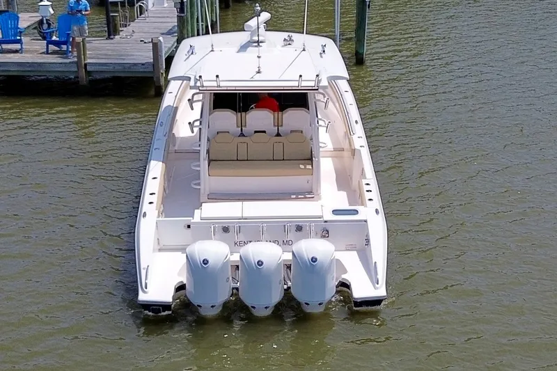 Slide: The Image of 2017 Pursuit S 408 Sport boat docked with triple engines, viewed from the rear. - 5