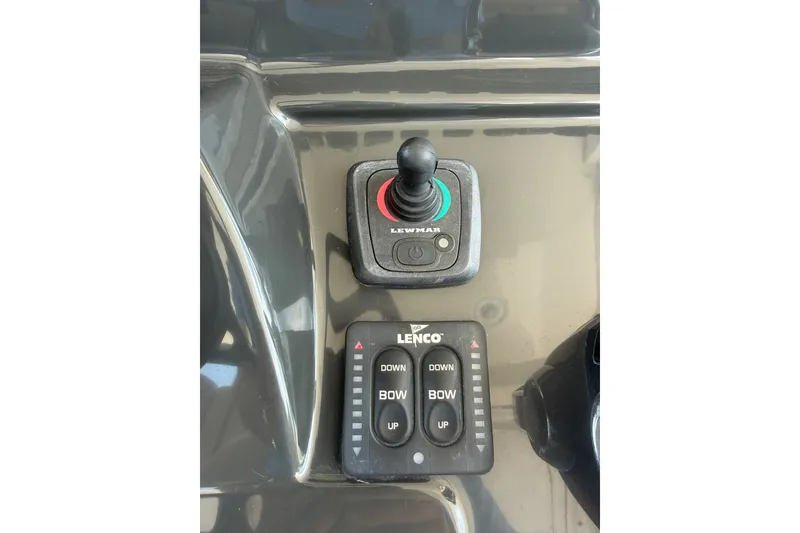 Slide: The Image of Control panel of a 2017 Pursuit S 408 Sport boat with joystick and trim tab buttons. - 51