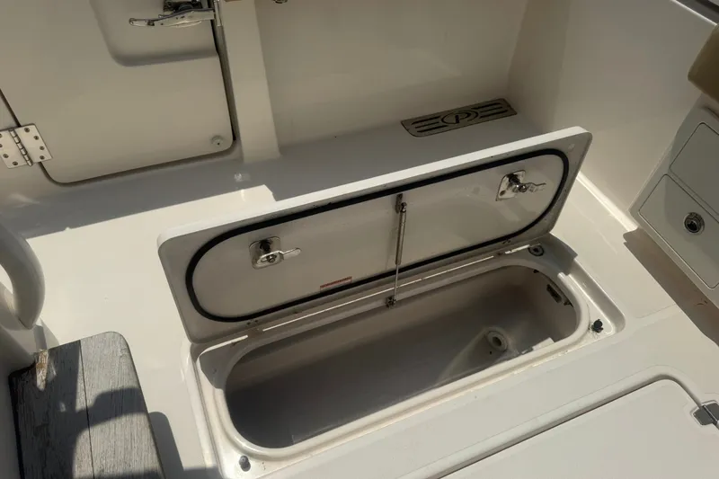 Slide: The Image of Open storage compartment on a 2017 Pursuit S 408 Sport boat deck. - 23