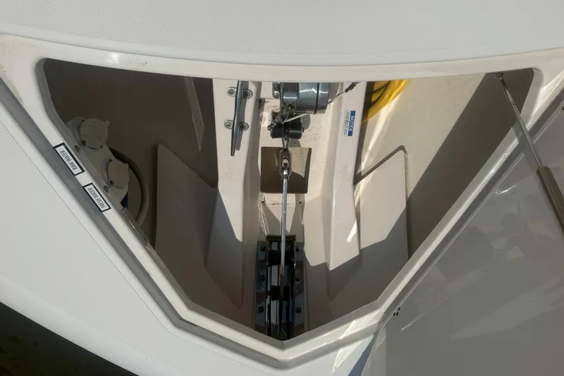 Slide: The Image of Anchor compartment of 2017 Pursuit S 408 Sport boat, showcasing winch and storage area. - 39
