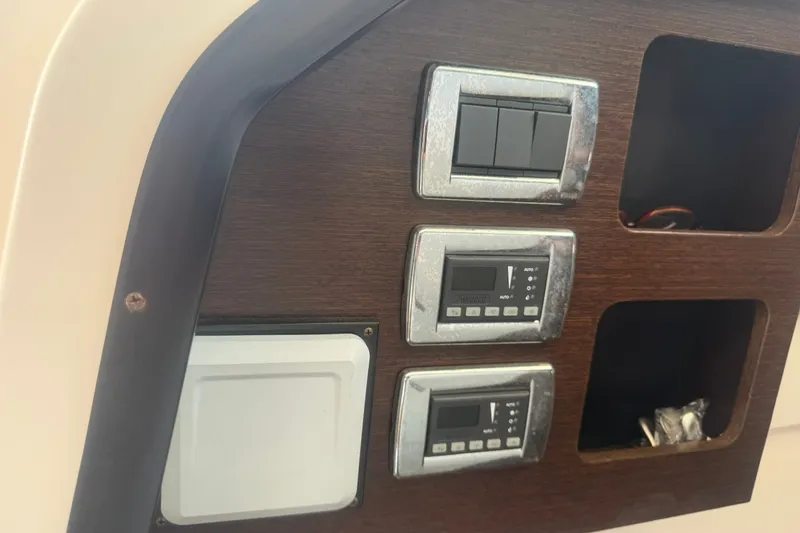 Slide: The Image of Control panel on 2017 Pursuit S 408 Sport boat with switches and digital displays. - 50