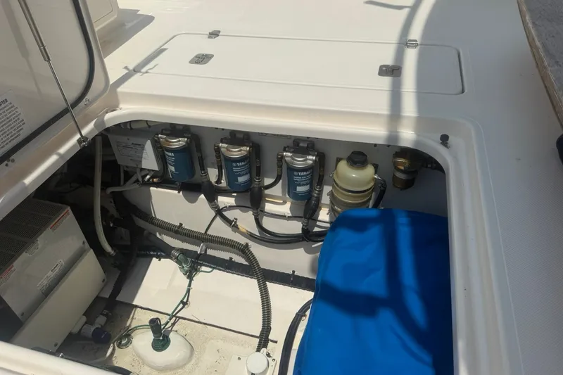 Slide: The Image of Engine compartment of a 2017 Pursuit S 408 Sport boat, showcasing Yamaha filters and components. - 33