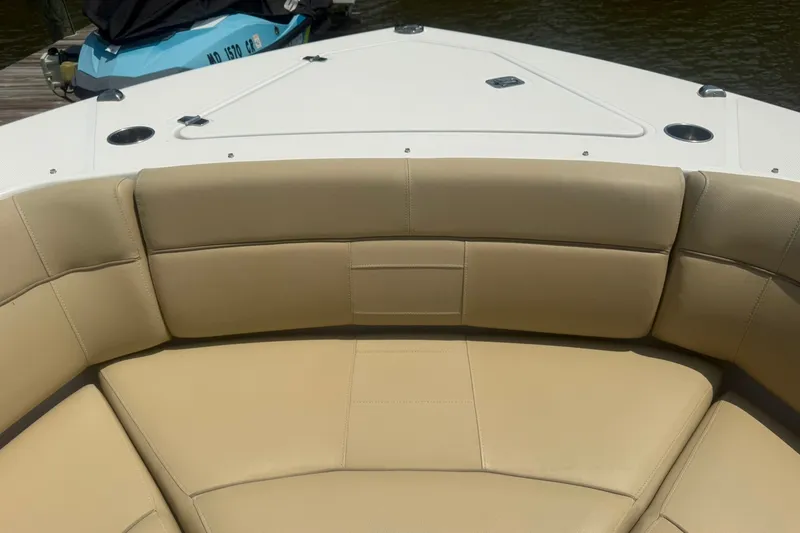Slide: The Image of Bow seating area of a 2017 Pursuit S 408 Sport boat with tan upholstery. - 37