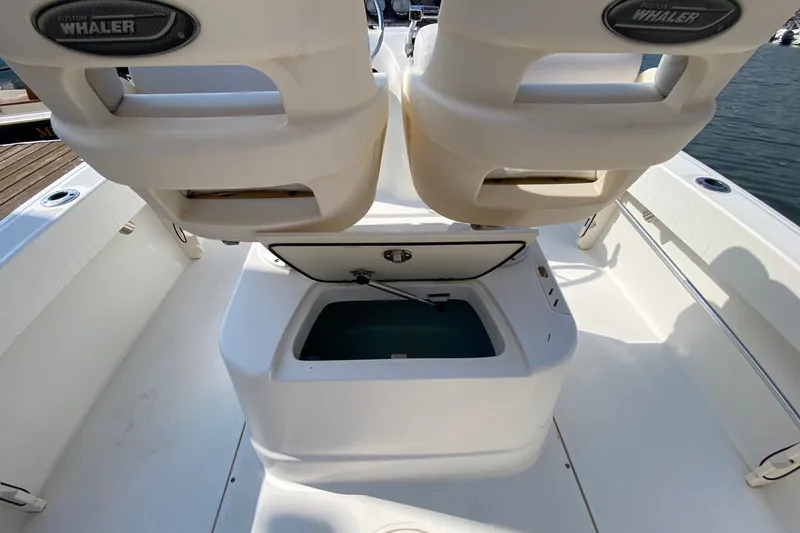 Slide: The Image of 2010 Boston Whaler 190 Outrage boat interior with open storage compartment and seating. - 16