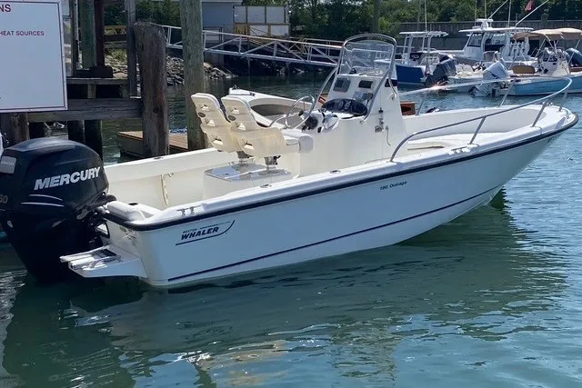 Slide: The Image of 2010 Boston Whaler 190 Outrage boat with Mercury engine docked in marina. - 8