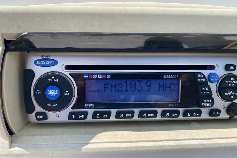 Slide: The Image of Jensen radio display in a 2010 Boston Whaler 190 Outrage, tuned to FM 103.9 MHz. - 13