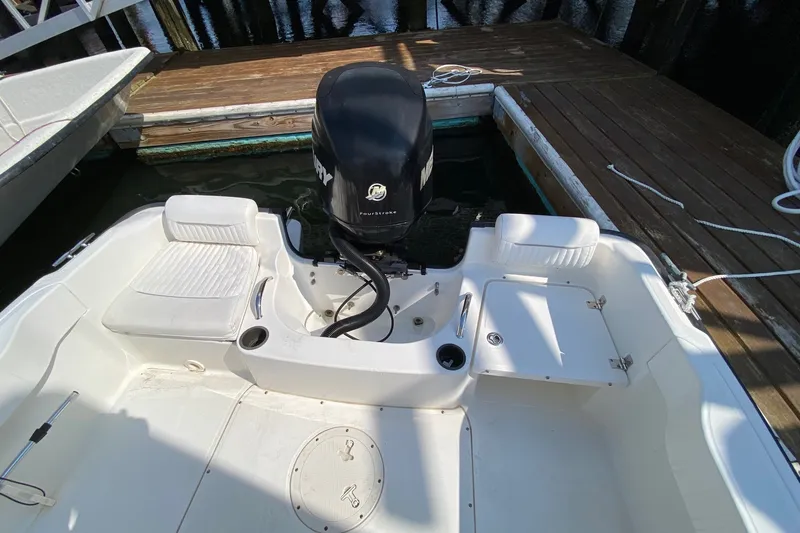 Slide: The Image of 2010 Boston Whaler 190 Outrage boat interior with Mercury engine at dock. - 15