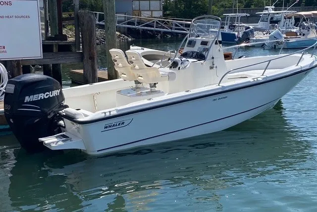 Slide: The Image of 2010 Boston Whaler 190 Outrage boat with Mercury engine docked in marina. - 4