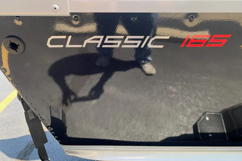 Slide: The Image of 2024 Alumacraft Classic 165 SC boat exterior with model name displayed. - 11