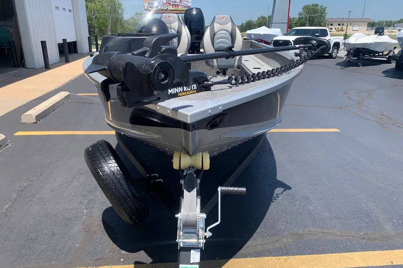 Slide: The Image of 2024 Alumacraft Classic 165 SC boat with Minn Kota PowerDrive, parked on a trailer. - 2
