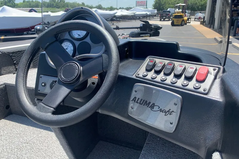 Slide: The Image of 2024 Alumacraft Classic 165 SC dashboard with steering wheel and control panel. - 9