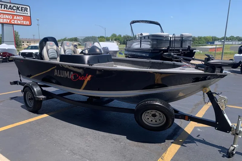 Slide: The Image of 2024 Alumacraft Classic 165 SC fishing boat on trailer at dealership. - 3