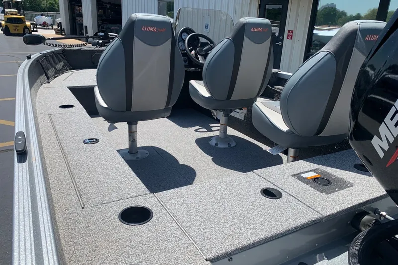 Slide: The Image of 2024 Alumacraft Classic 165 SC boat interior with seating and fishing deck. - 5