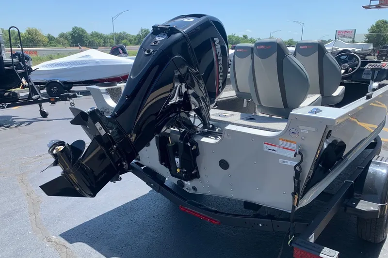 Slide: The Image of 2024 Alumacraft Classic 165 SC boat with Mercury outboard motor, parked on a trailer. - 4