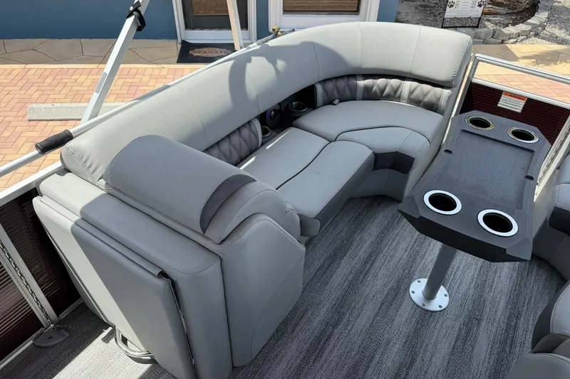 Slide: The Image of 2023 Bennington 23 LXFB pontoon boat interior with plush seating and cup holders. - 23
