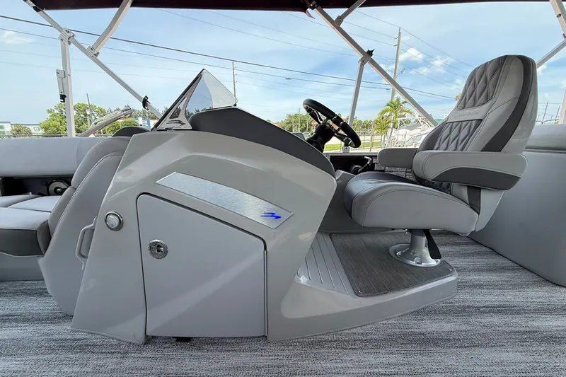 Slide: The Image of 2023 Bennington 23 LXFB boat interior with captain's chair and steering console. - 21