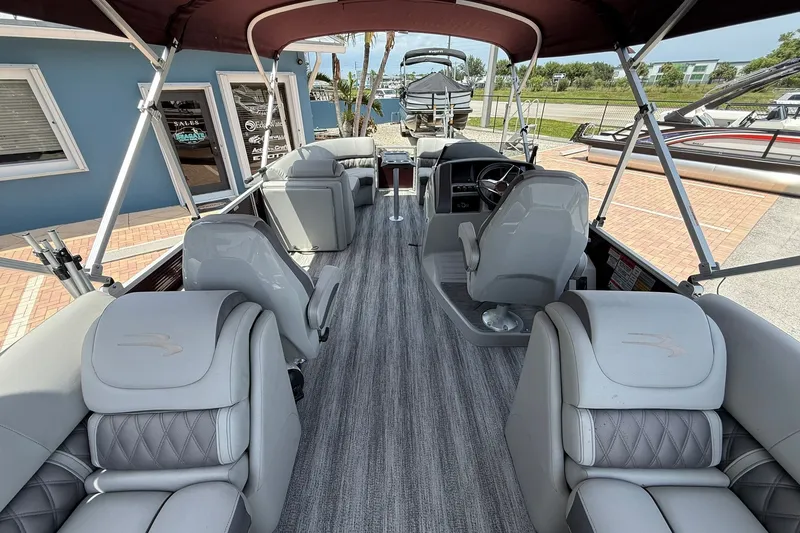 Slide: The Image of 2023 Bennington 23 LXFB pontoon boat interior with luxurious seating and modern design. - 11
