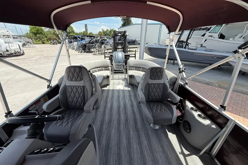 Slide: The Image of Interior of a 2023 Bennington 23 LXFB pontoon boat with luxurious seating and canopy. - 19