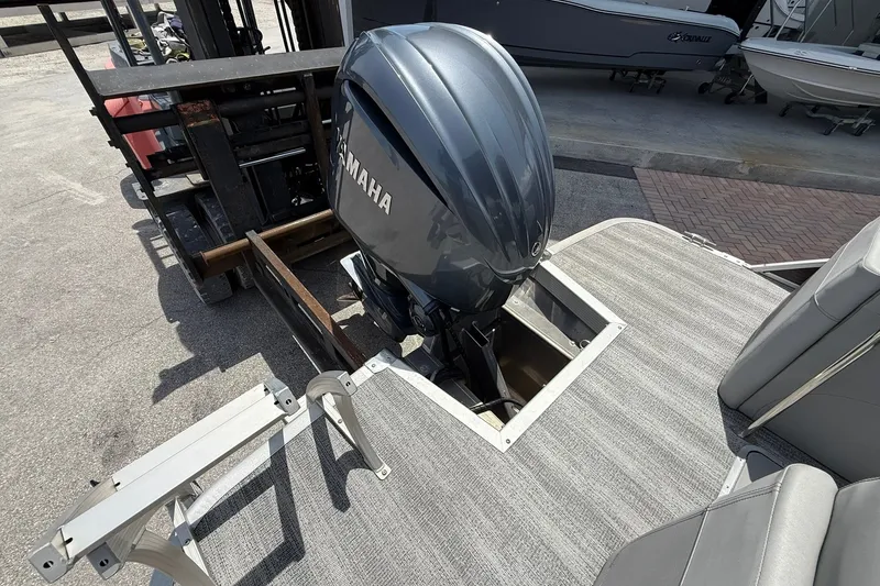 Slide: The Image of 2023 Bennington 23 LXFB boat with Yamaha outboard motor on deck. - 6