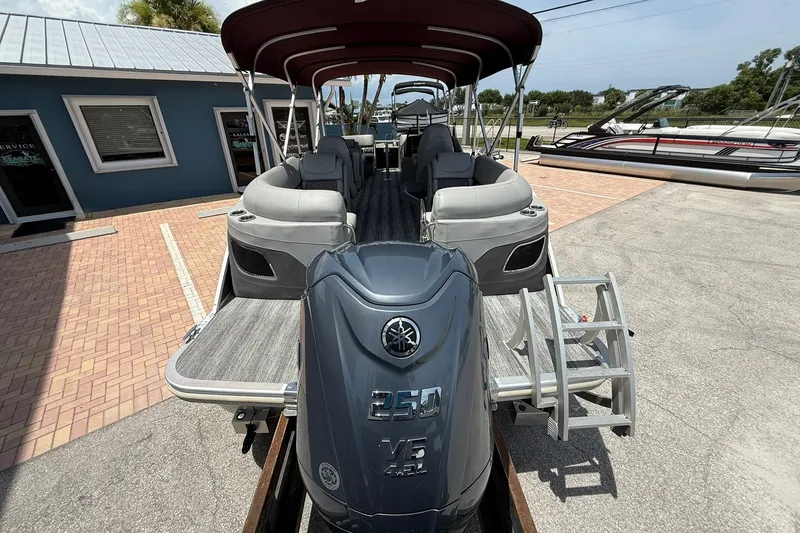 Slide: The Image of 2023 Bennington 23 LXFB pontoon boat with Yamaha 250 V6 engine, docked outdoors. - 5