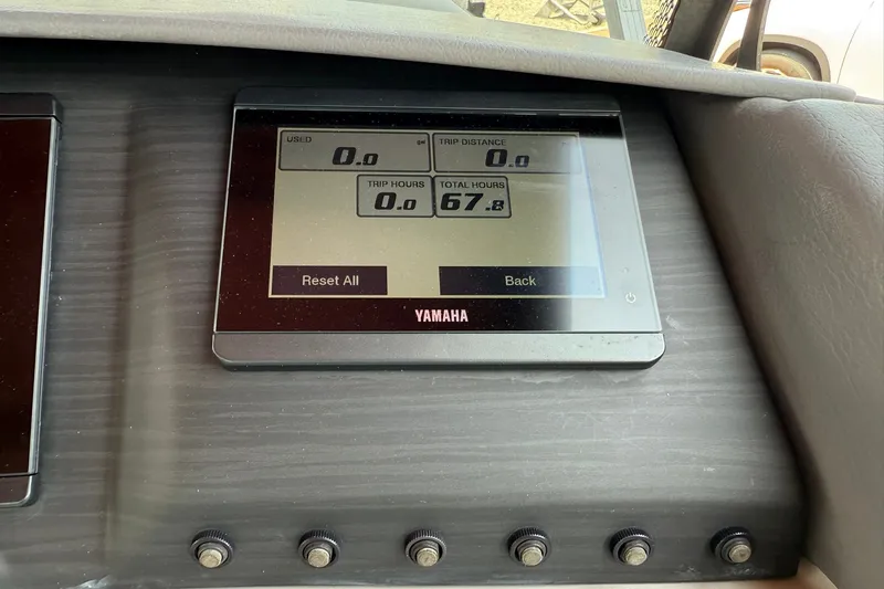 Slide: The Image of Yamaha display on 2023 Bennington 23 LXFB showing trip and total hours. - 17