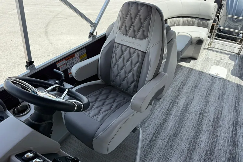 Slide: The Image of Captain's chair on 2023 Bennington 23 LXFB pontoon boat with luxurious seating and steering wheel. - 18